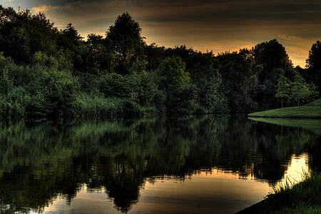 body of water near green trees thumbnail
