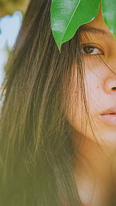 woman standing near green leaf thumbnail