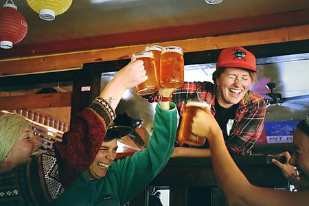 women smiling while holding beer mugs thumbnail