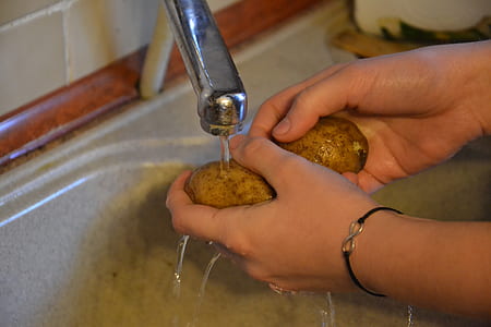 person holding two potatoes thumbnail