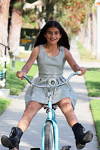 girl riding on bicycle on pathway thumbnail