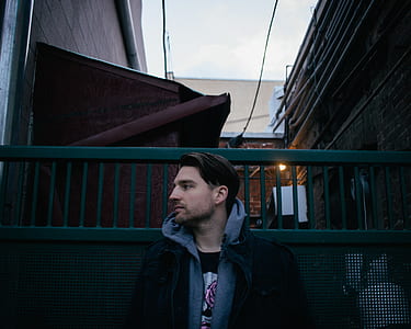 man standing between building thumbnail