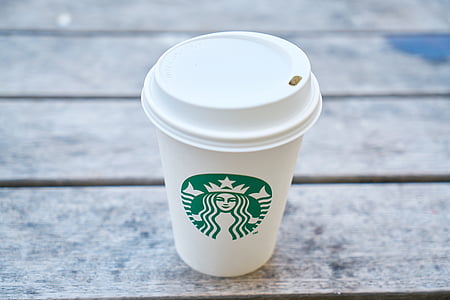 Starbucks disposable cup on brown wooden surface thumbnail