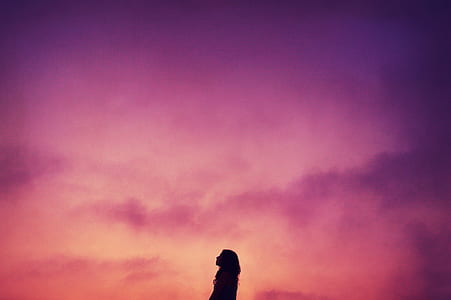 silhouette photo of woman under purple sky thumbnail