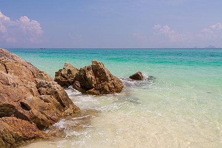 landscape photography of boulders on ocean shore thumbnail