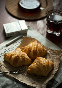 photo of croissant serving on brown paper bag thumbnail