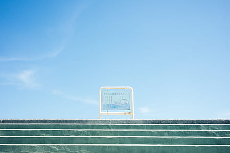 in distant photo of signage on top of stair thumbnail