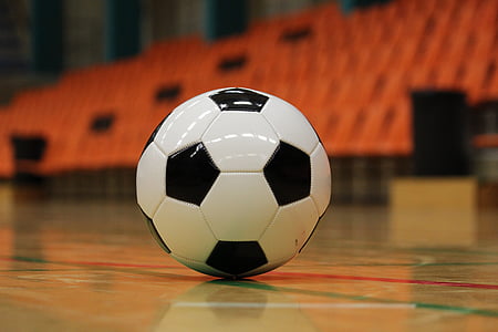 white and black soccer ball on brown ground thumbnail