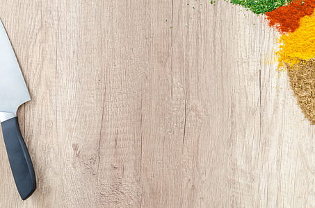 grey cutting knife placed on brown wooden surface thumbnail