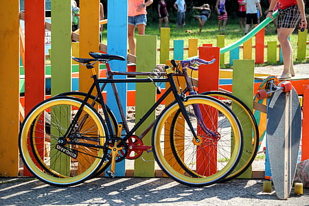 two black road bikes parked beside fence thumbnail