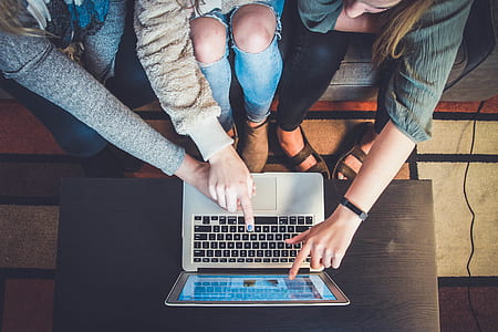 three person touching MacBook Air on table thumbnail