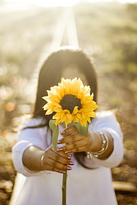 woman holding sunflower thumbnail