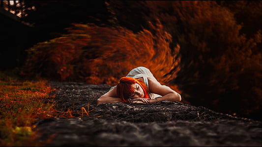 red-dyed haired woman in white dress lying on ground thumbnail