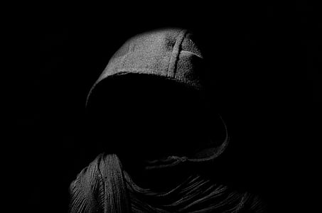 person wearing gray hoodie inside dark room thumbnail