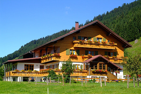brown painted 3-storey house surrounded by trees thumbnail