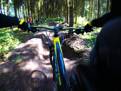 person riding bicycle going down in mountain thumbnail