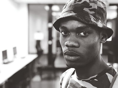 Man Wearing Camouflage Crew-neck T-shirt and Hat thumbnail