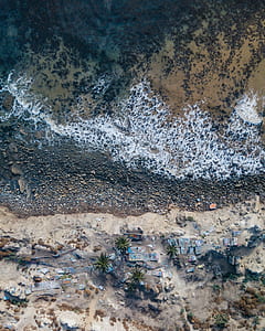 aerial photo of village beside body of water thumbnail