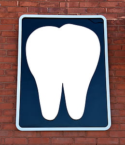 white tooth board on brown brick wall thumbnail