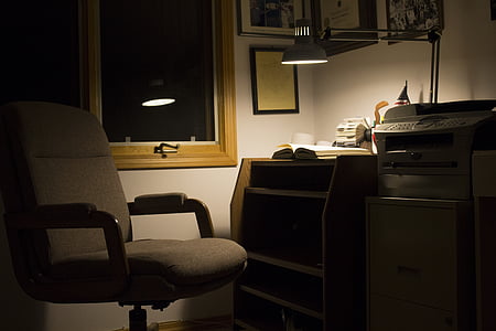 rolling chair beside computer desk and copier machine thumbnail