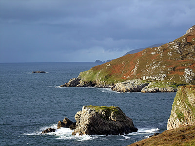 gray islet with cloudy sky thumbnail