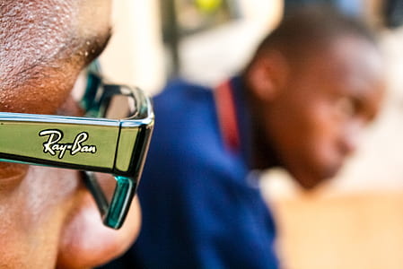 selective focus photography of man wearing Ray-Ban sunglasses thumbnail