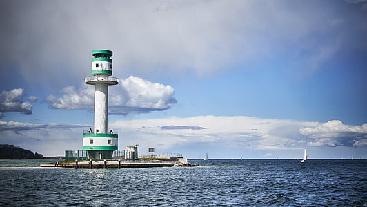 white lighthouse near body of water thumbnail
