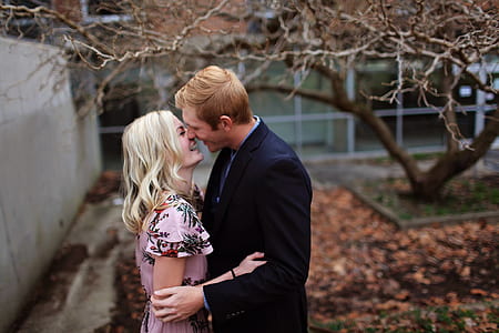 Smiling Couple Standing Near Bare Tree Outdoors Macro Shot thumbnail
