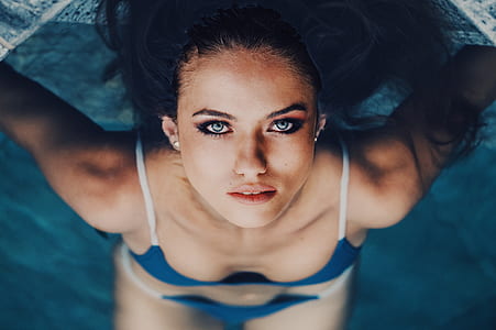 woman looking on top-view while swimming on pool during daytime thumbnail