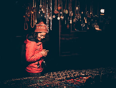 woman standing while smiling and looking to souvenirs thumbnail