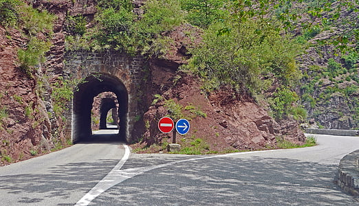 gray tunnel near concrete road at daytime thumbnail
