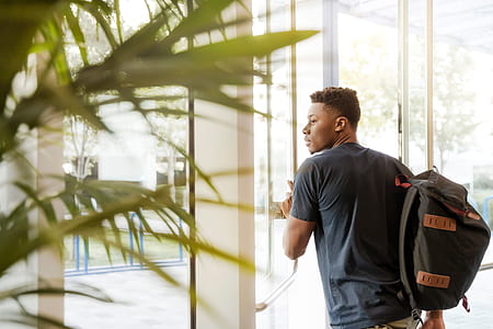 man carrying a bag holding glass door thumbnail