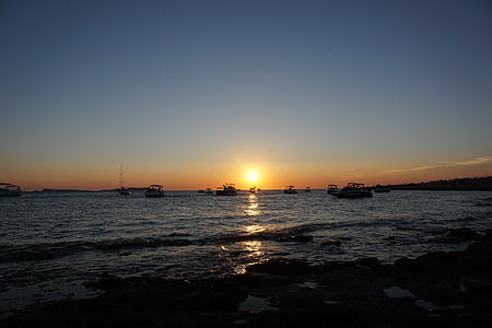 boats on sea at golden hour thumbnail
