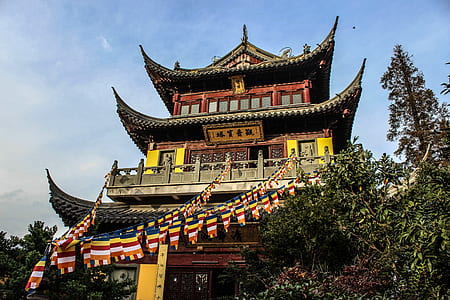 gray, red, and black pagoda near trees thumbnail