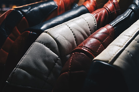 selective focus photography of hanged leather apparels thumbnail