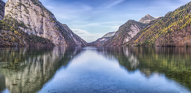 body of water surrounded by mountains thumbnail