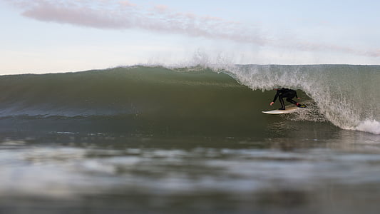 man surfing under gloomy sky thumbnail