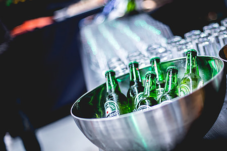 closeup photography of green glass bottles in gray bowl thumbnail