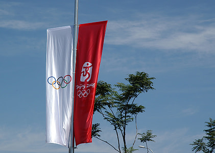 two red and white Olympic banners rising thumbnail