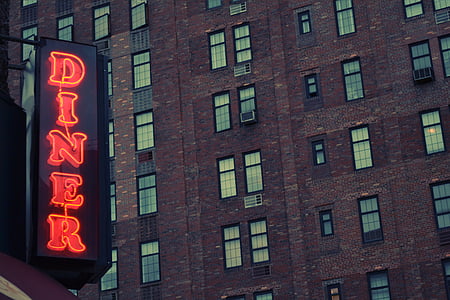 red Diner neon signage on brown concrete building thumbnail