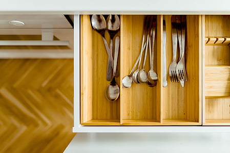 gray steel utensils in beige wooden organizer drawer thumbnail