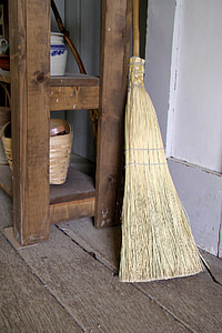brown and beige broom leaning on table thumbnail