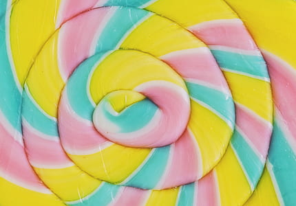 closeup photo of spiral yellow and multicolored candy thumbnail