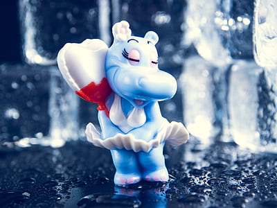 close-up photography of hippopotamus wearing white dress with heart balloon ceramic figurine thumbnail