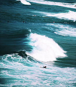group of surfers on body of water thumbnail
