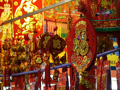 closeup photo of red and gold hanging decor thumbnail