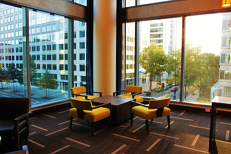 Brown Coffee Table Surrounded by Four Chairs thumbnail