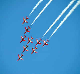 red-and-white jet planes in the sky and emitting white smoke thumbnail