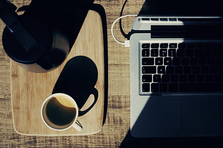 flat lay photography of mug beside kettle and laptop thumbnail