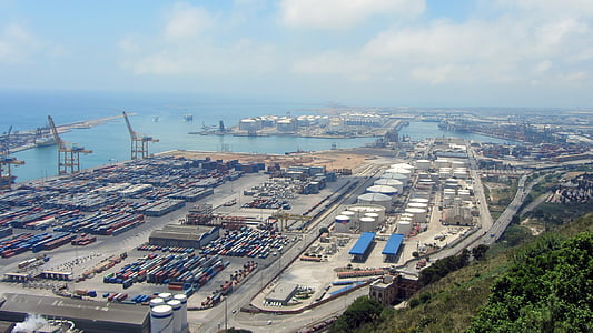 intermodal containers on ground beside body of water thumbnail